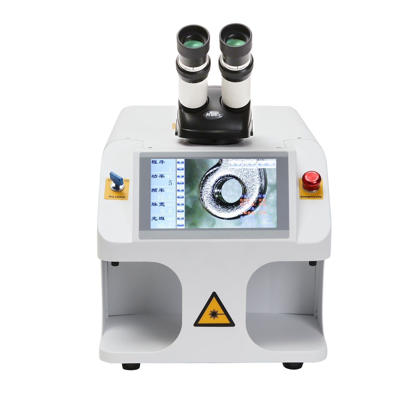 Front view of the compact jewelry laser welder with binocular microscope, key switch, emergency stop and touch screen showing a magnified part