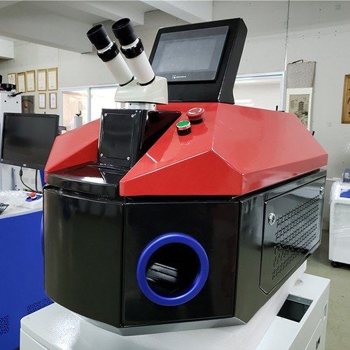 Jewelry laser welder in a red and black cabinet with microscope and touch screen, showroom photo