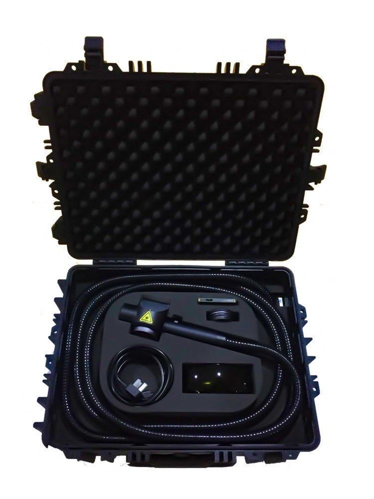 Open case of the 100 W laser rust remover showing the coiled fiber cable and cleaning head in foam inserts