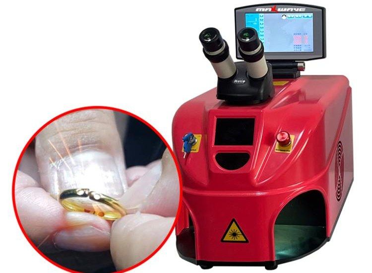 Three-quarter view of the integrated jewelry welder, with an inset of a gold ring being welded